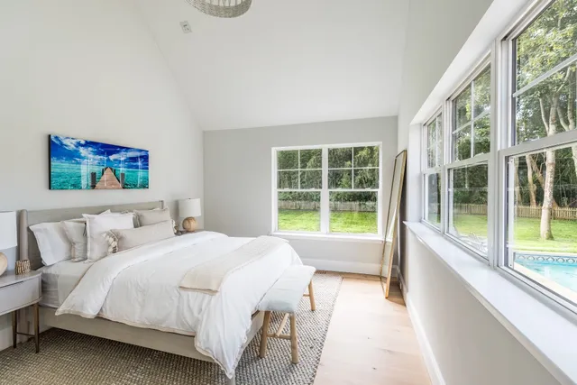 a bedroom with a large bed and a large window