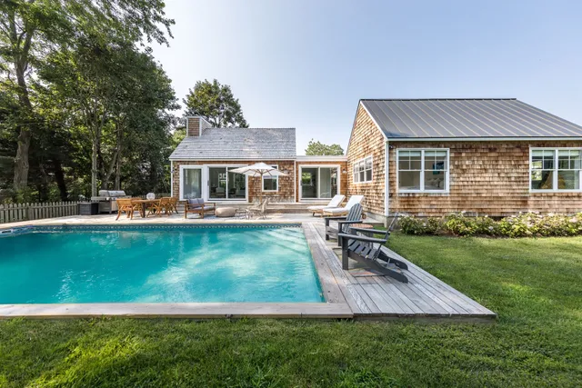 a view of a house with a yard patio and swimming pool