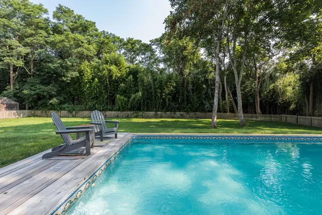 a view of a swimming pool with a yard
