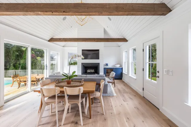 a dining room with furniture and wooden floor