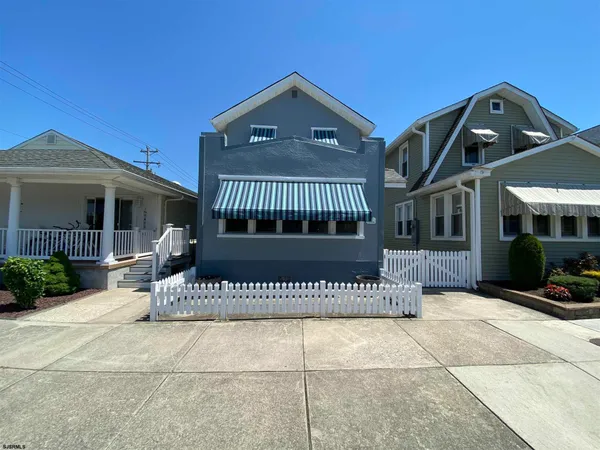 a front view of a house with a iron gate
