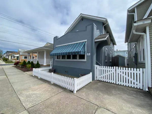 a front view of a house with iron fence