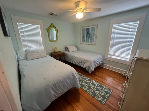 a bedroom with two beds and a window