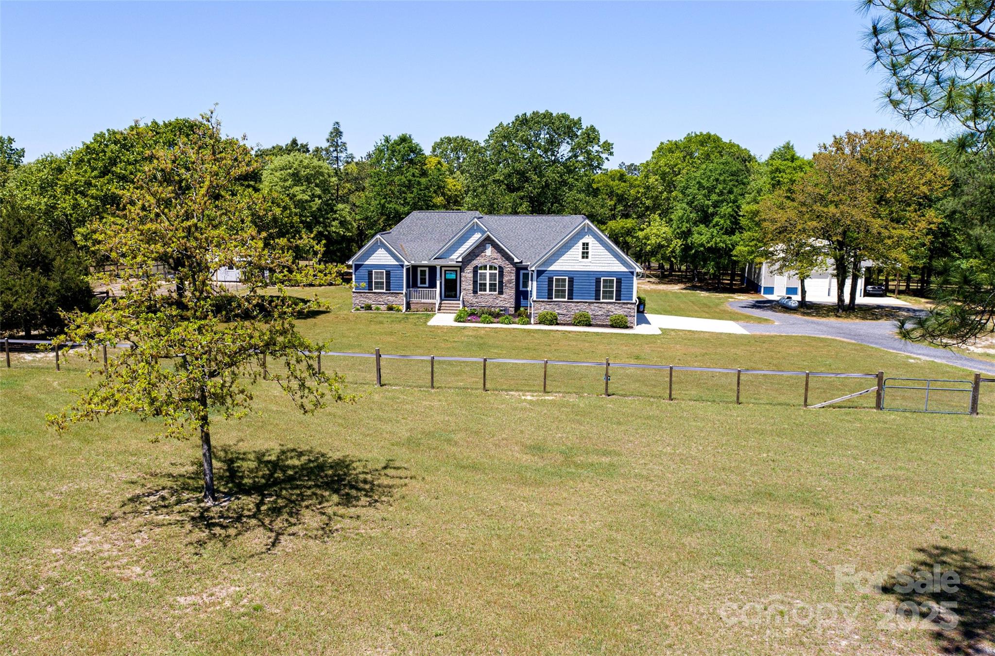 a view of a large garden with a house in the background