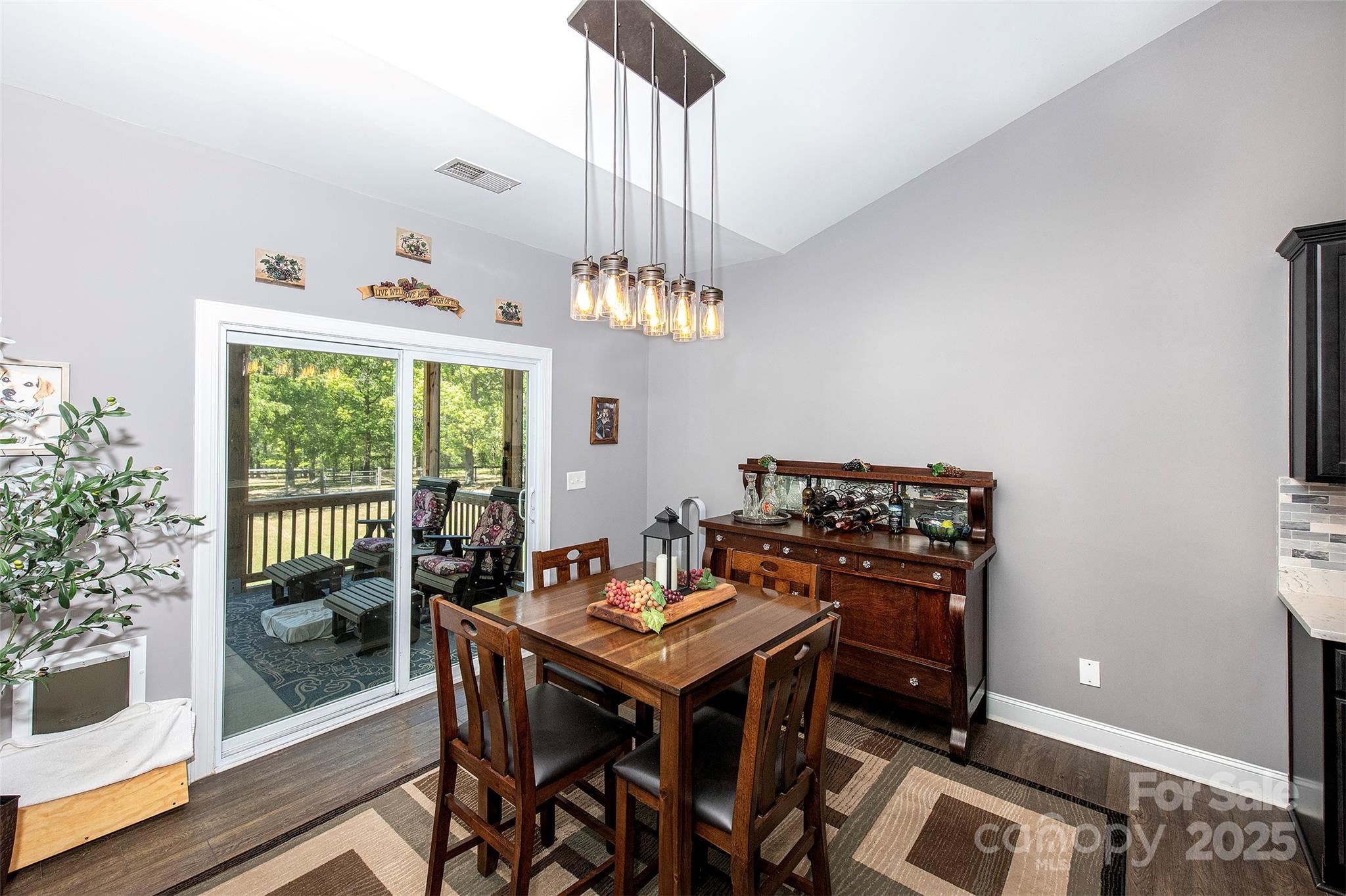 340 Hound Holw Road Camden, SC 29020 - Photo 13 of 28 a view of a dining room with furniture a chandelier and wooden floor