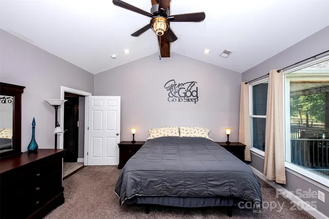 a bedroom with a bed dresser and a window