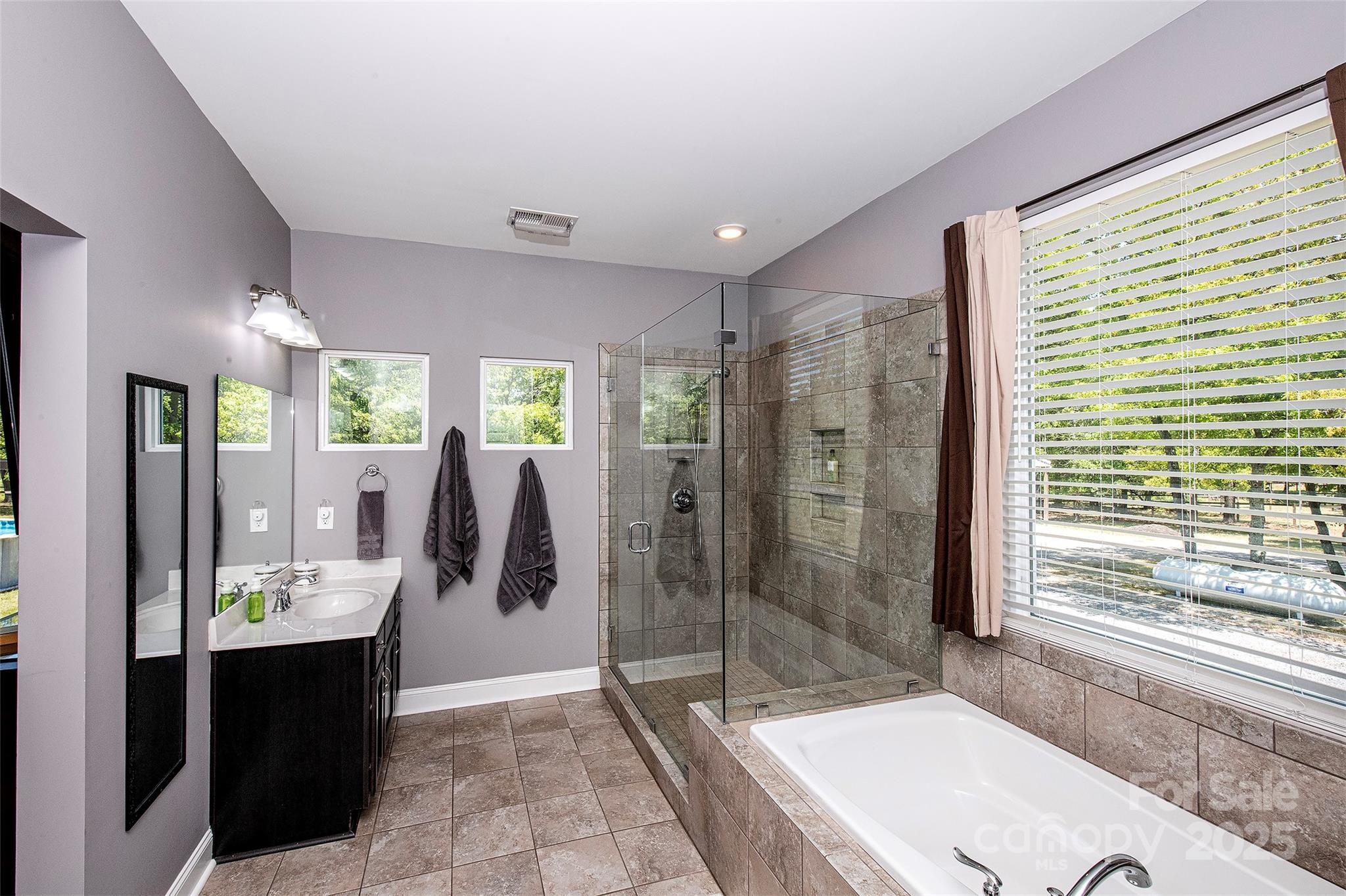 340 Hound Holw Road Camden, SC 29020 - Photo 20 of 28 a bathroom with a granite countertop sink a large mirror and shower