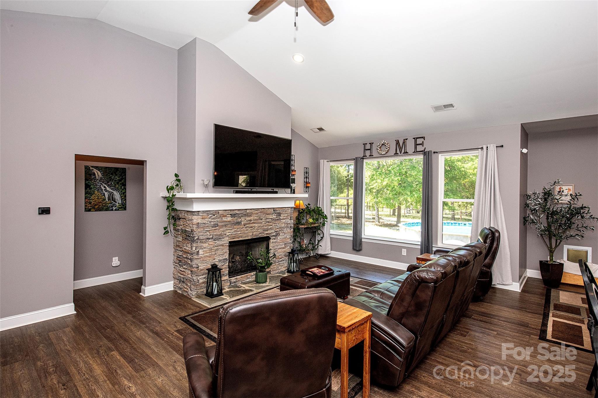 340 Hound Holw Road Camden, SC 29020 - Photo 9 of 28 a living room with furniture a flat screen tv and a fireplace