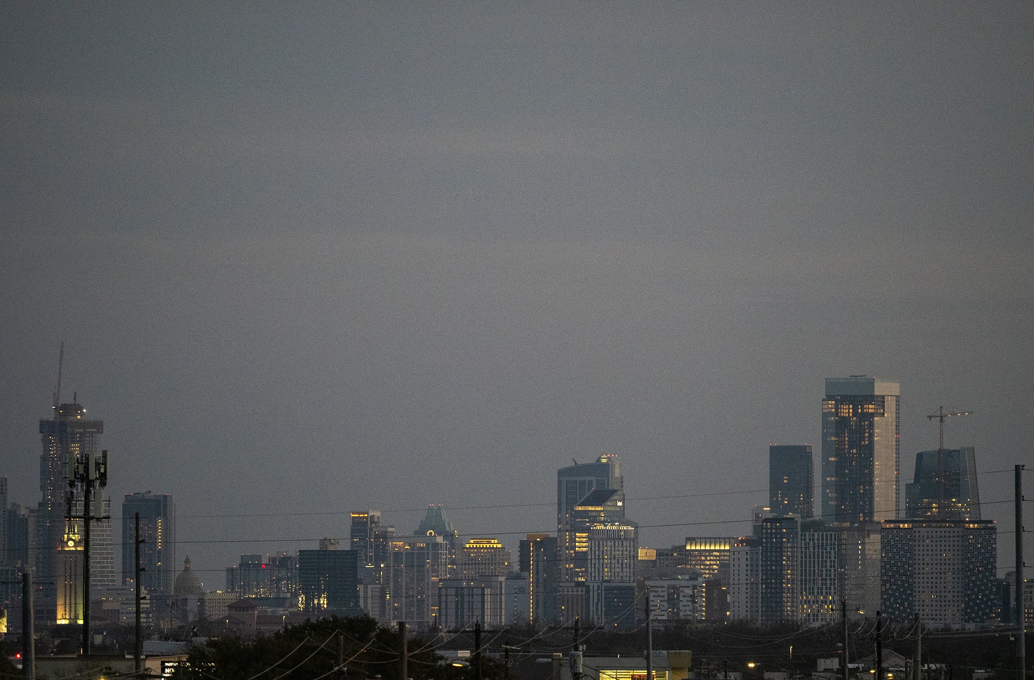 6444 Burnet Road, Unit 509 Austin, TX 78757 - Photo 30 of 32 Distant city skyline illuminated at dusk, showcasing urban development and architectural grandeur.