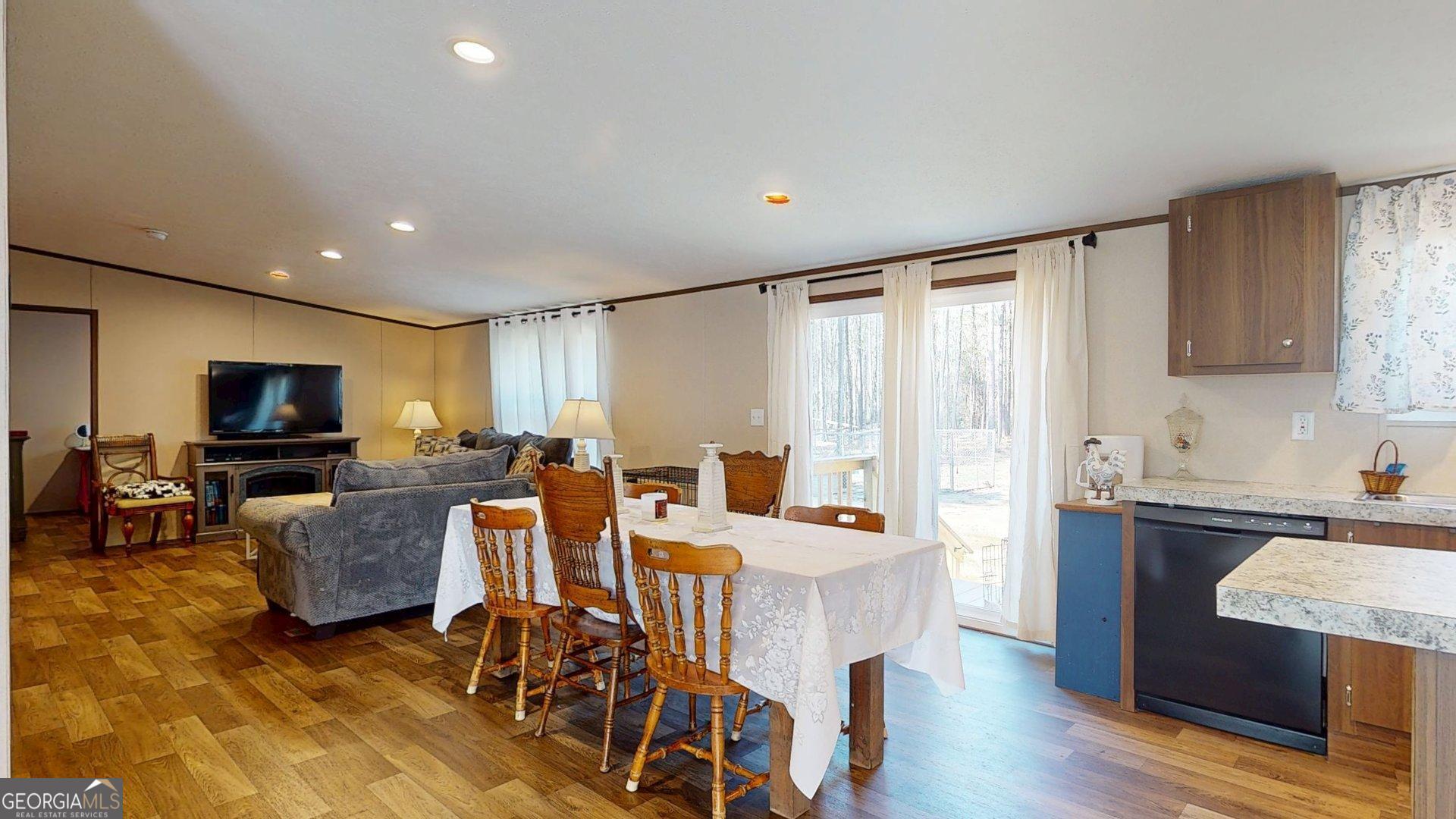 5571 Old Dixie Highway South Springfield, GA 31329 - Photo 14 of 38 a living room with furniture a flat screen tv and kitchen view