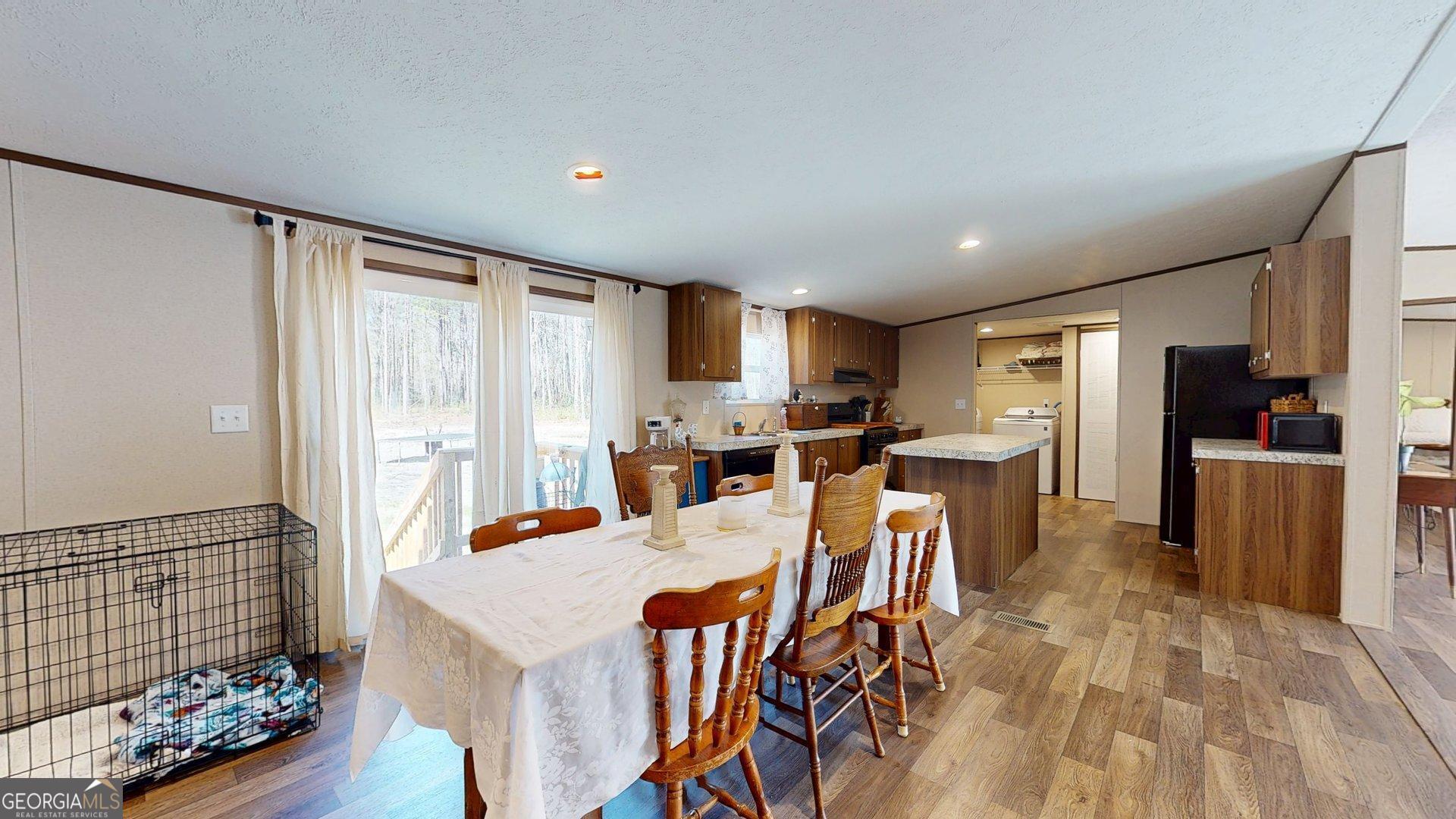 5571 Old Dixie Highway South Springfield, GA 31329 - Photo 16 of 38 a view of a dining room with furniture window and wooden floor