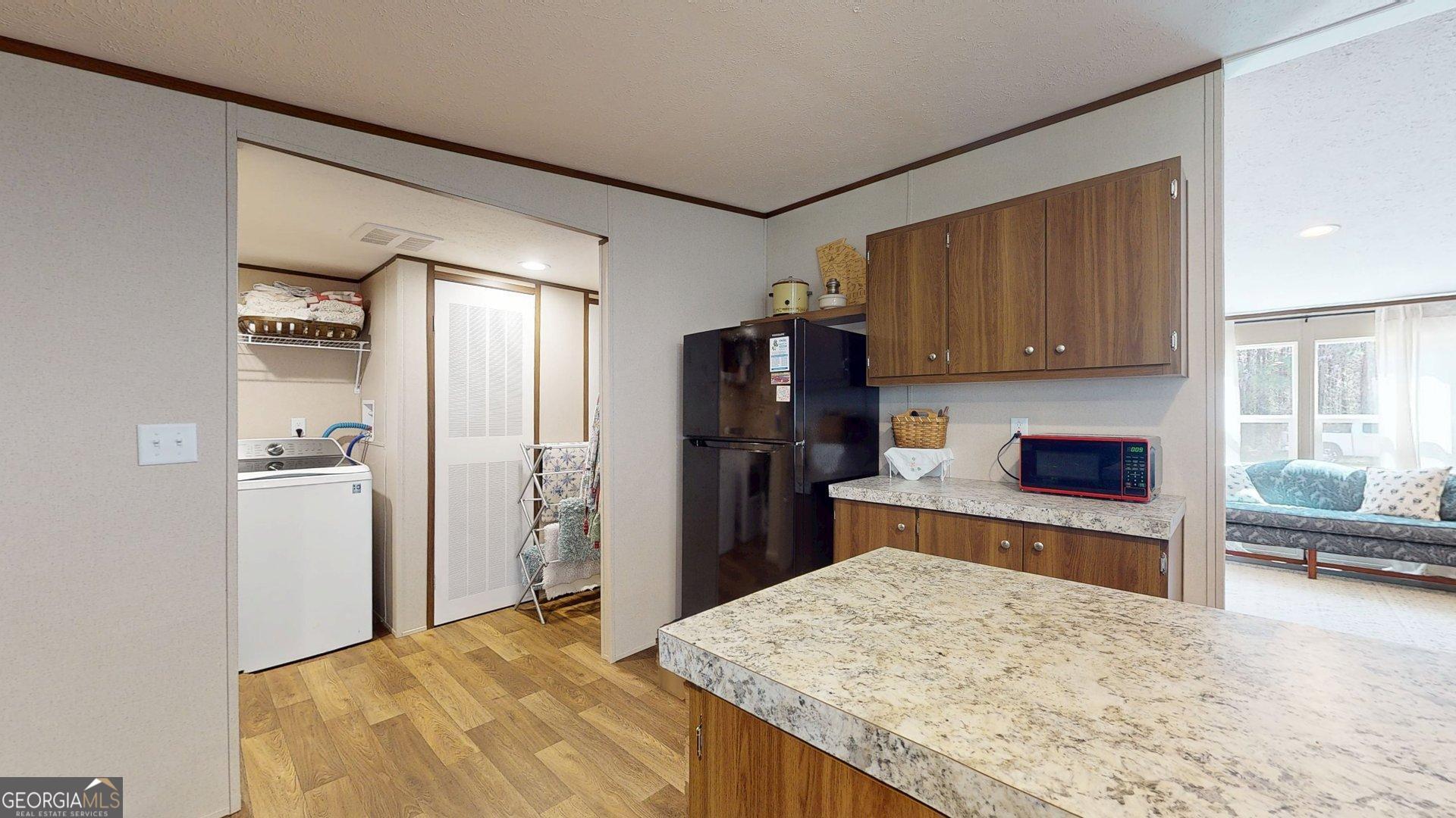 5571 Old Dixie Highway South Springfield, GA 31329 - Photo 17 of 38 a kitchen with a refrigerator and a stove top oven