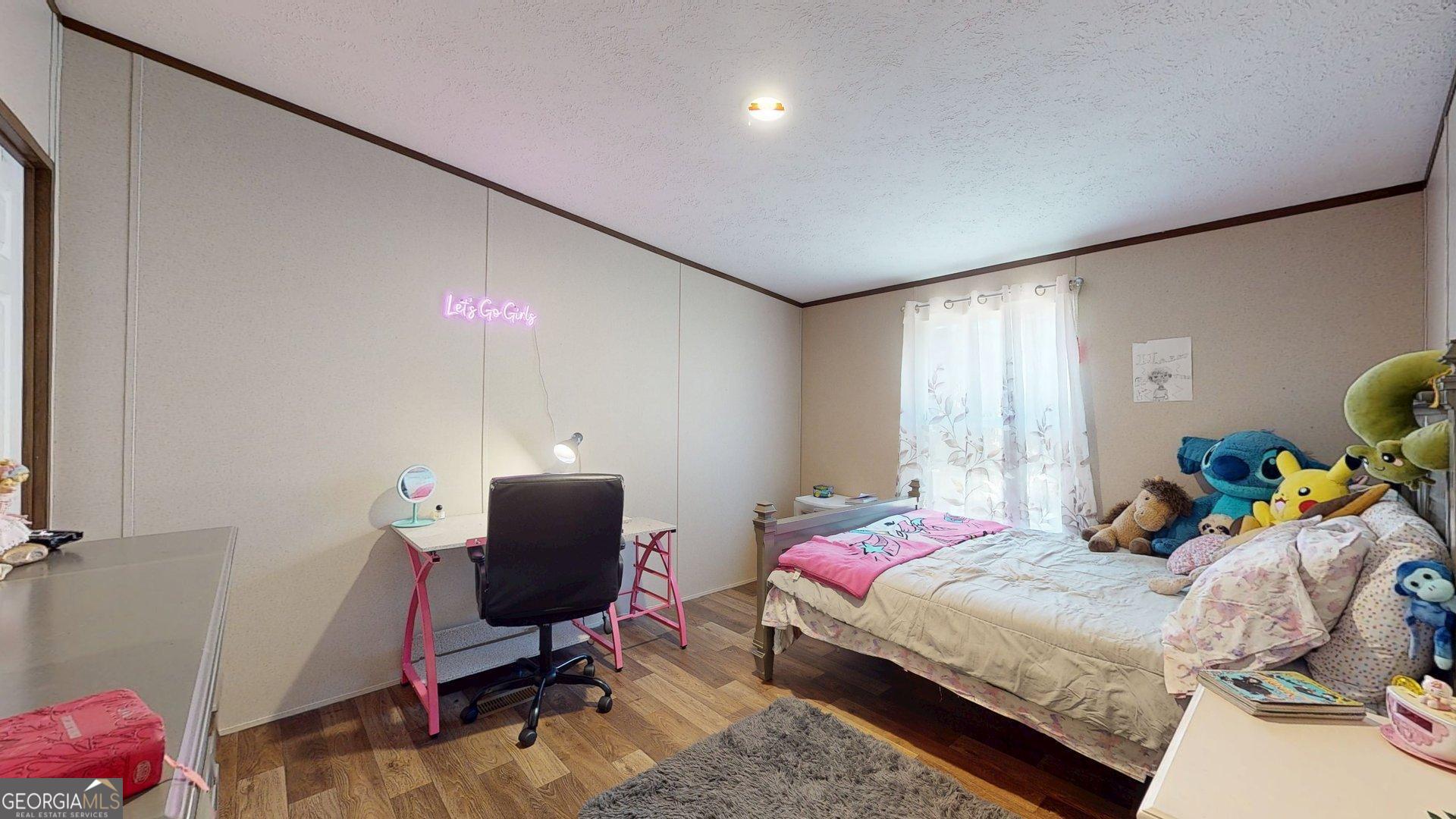 5571 Old Dixie Highway South Springfield, GA 31329 - Photo 18 of 38 a bedroom with a bed and gym equipment