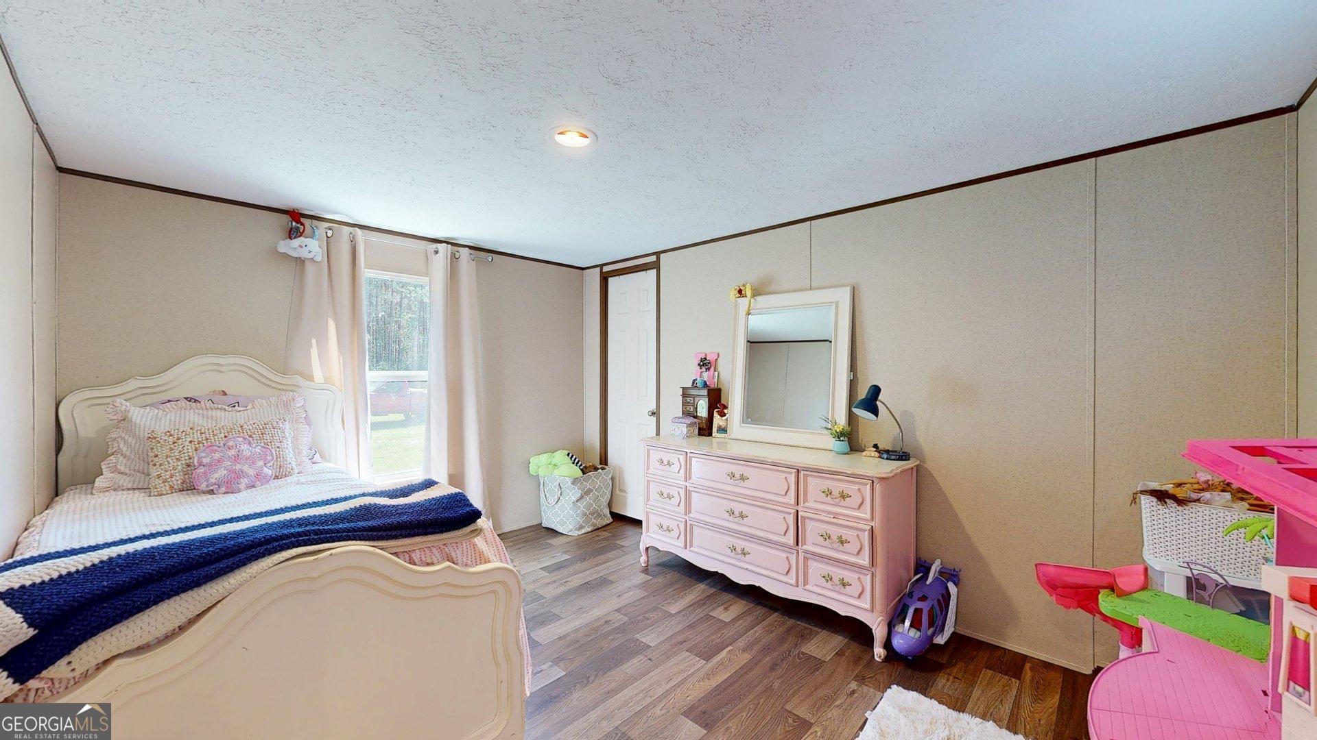 5571 Old Dixie Highway South Springfield, GA 31329 - Photo 19 of 38 a bedroom with a bed and a window