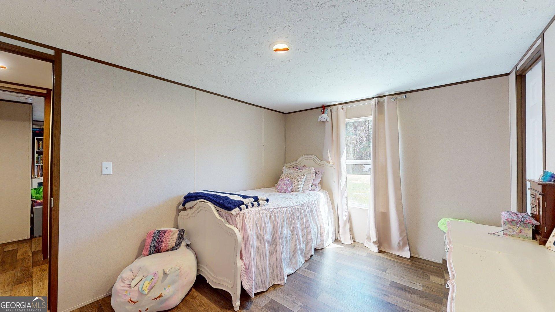 5571 Old Dixie Highway South Springfield, GA 31329 - Photo 20 of 38 a bedroom with a bed and wooden floor