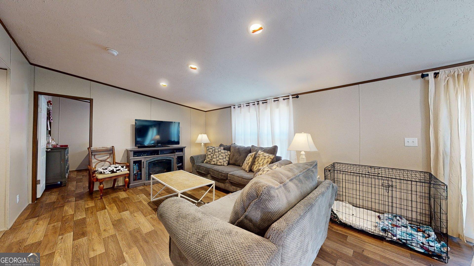 5571 Old Dixie Highway South Springfield, GA 31329 - Photo 22 of 38 a living room with furniture and a flat screen tv