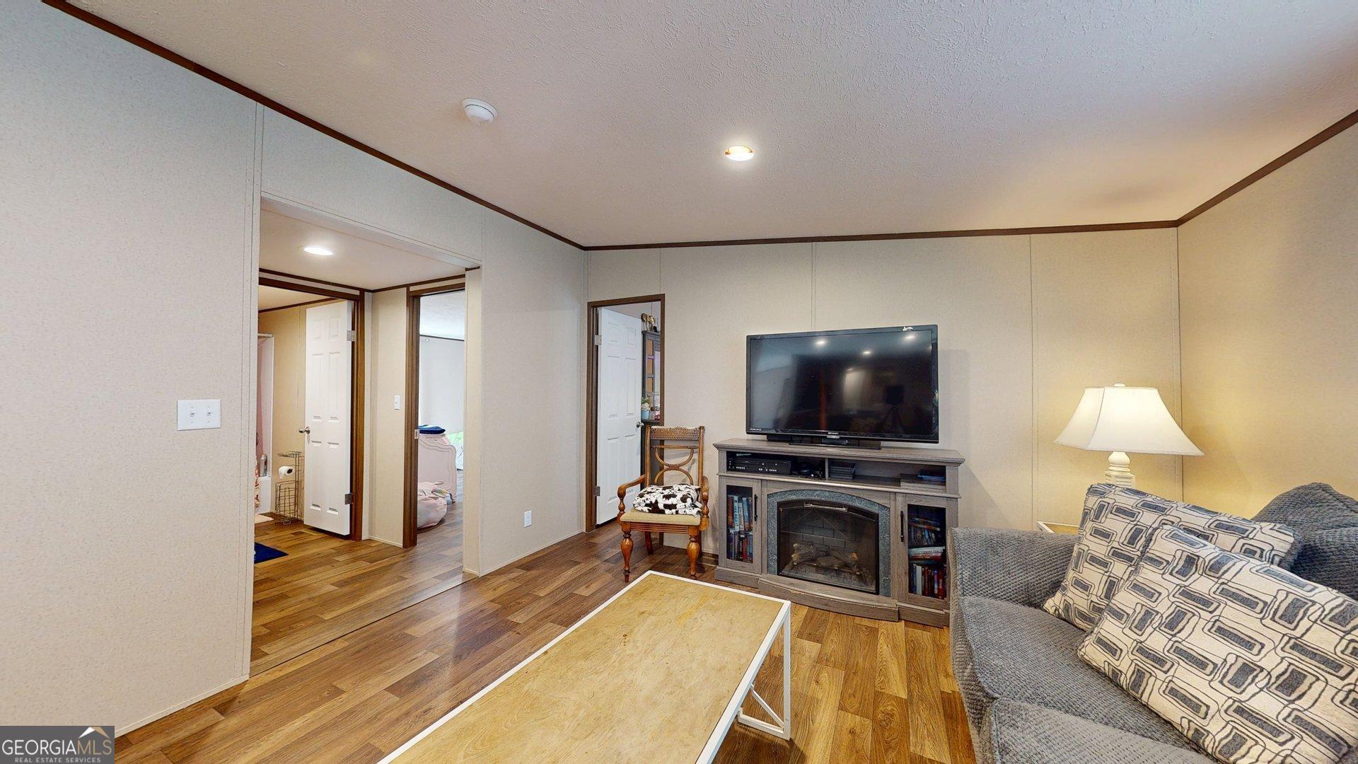 5571 Old Dixie Highway South Springfield, GA 31329 - Photo 26 of 38 a living room with furniture and a flat screen tv