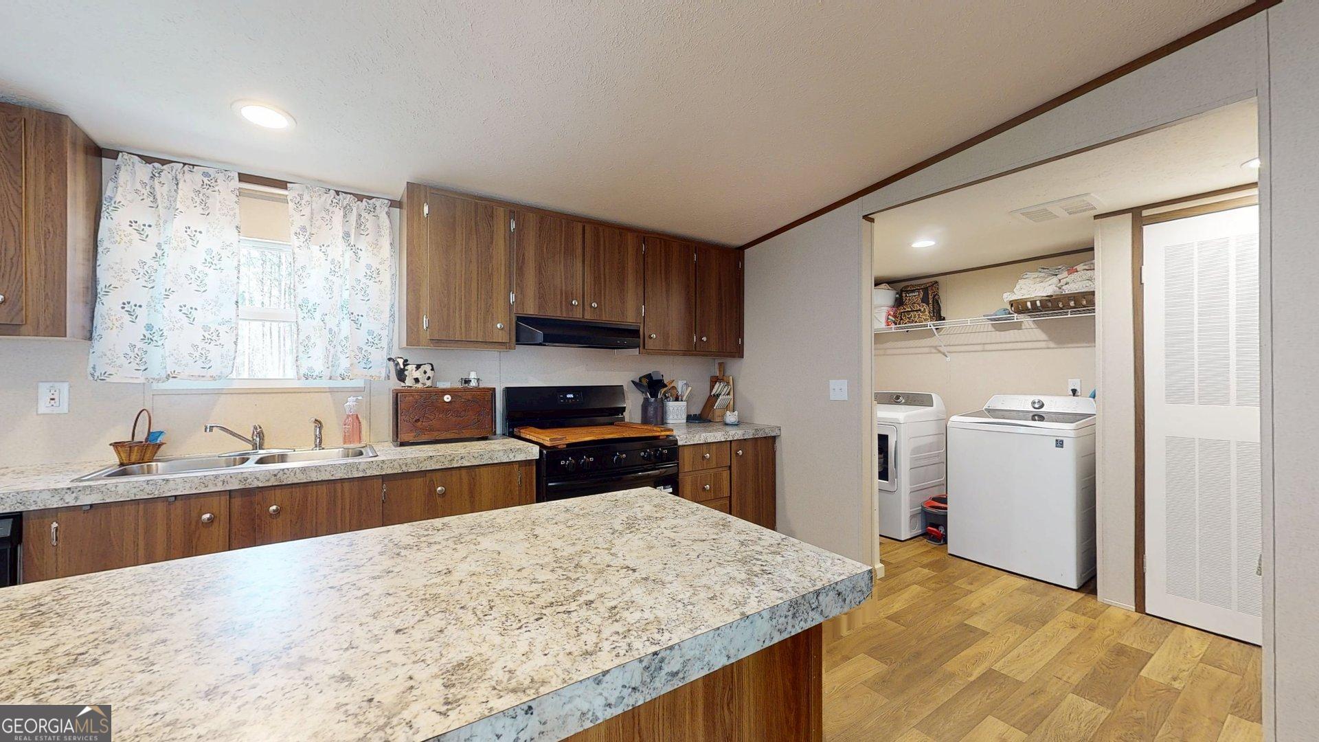 5571 Old Dixie Highway South Springfield, GA 31329 - Photo 27 of 38 a kitchen with a sink stove and refrigerator