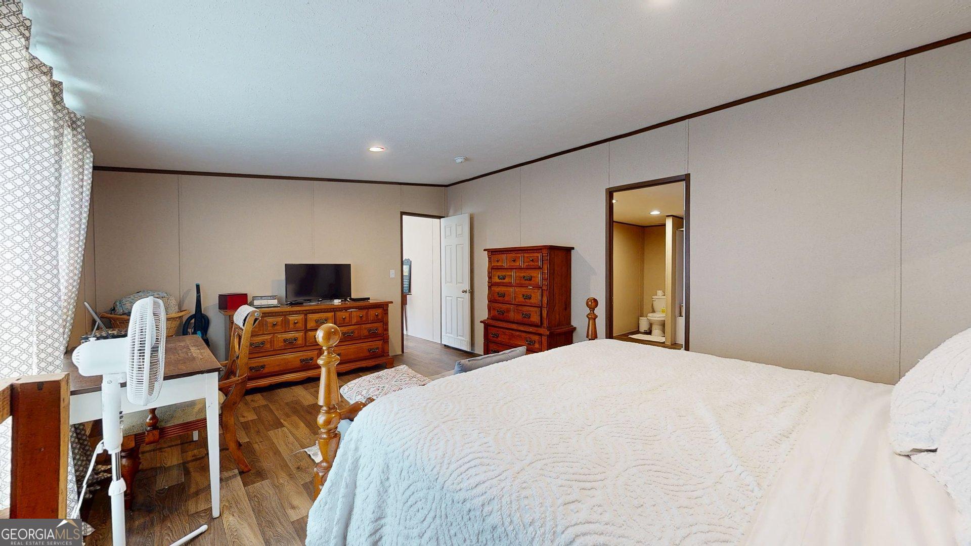 5571 Old Dixie Highway South Springfield, GA 31329 - Photo 29 of 38 a bedroom with a bed and a flat screen tv