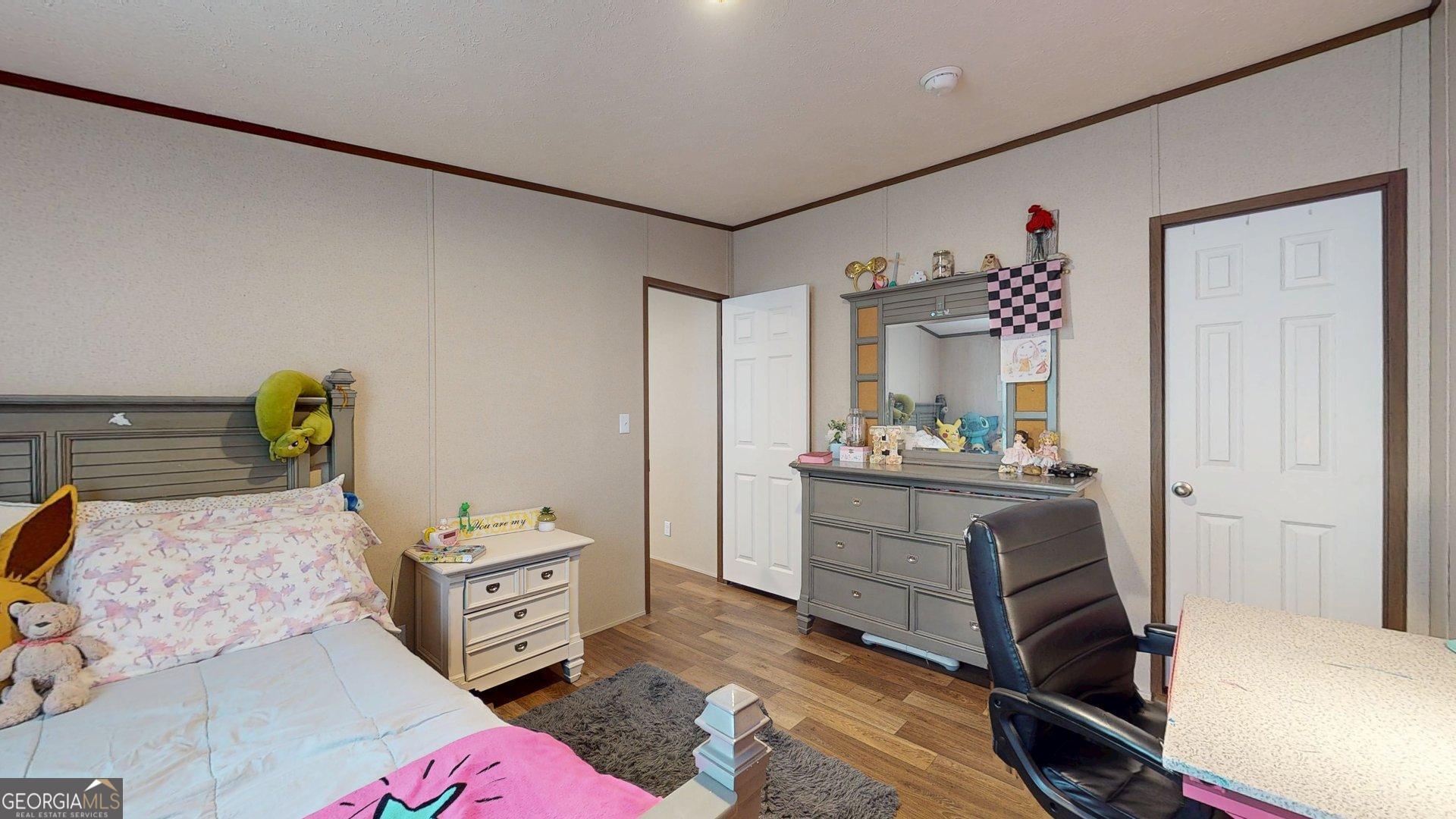 5571 Old Dixie Highway South Springfield, GA 31329 - Photo 31 of 38 a bedroom with a bed and a mirror