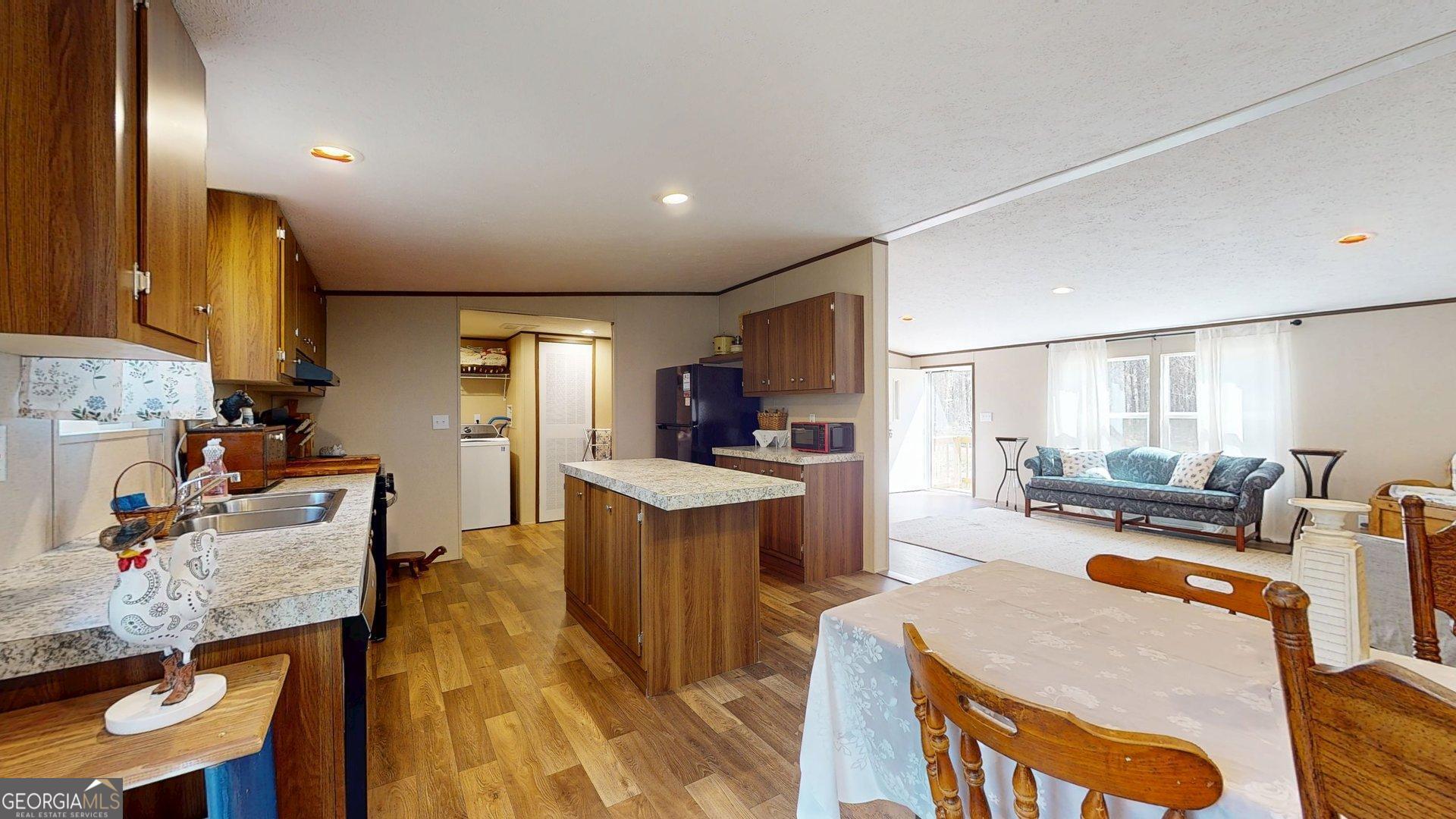 5571 Old Dixie Highway South Springfield, GA 31329 - Photo 37 of 38 a living room with stainless steel appliances furniture stove and a kitchen view