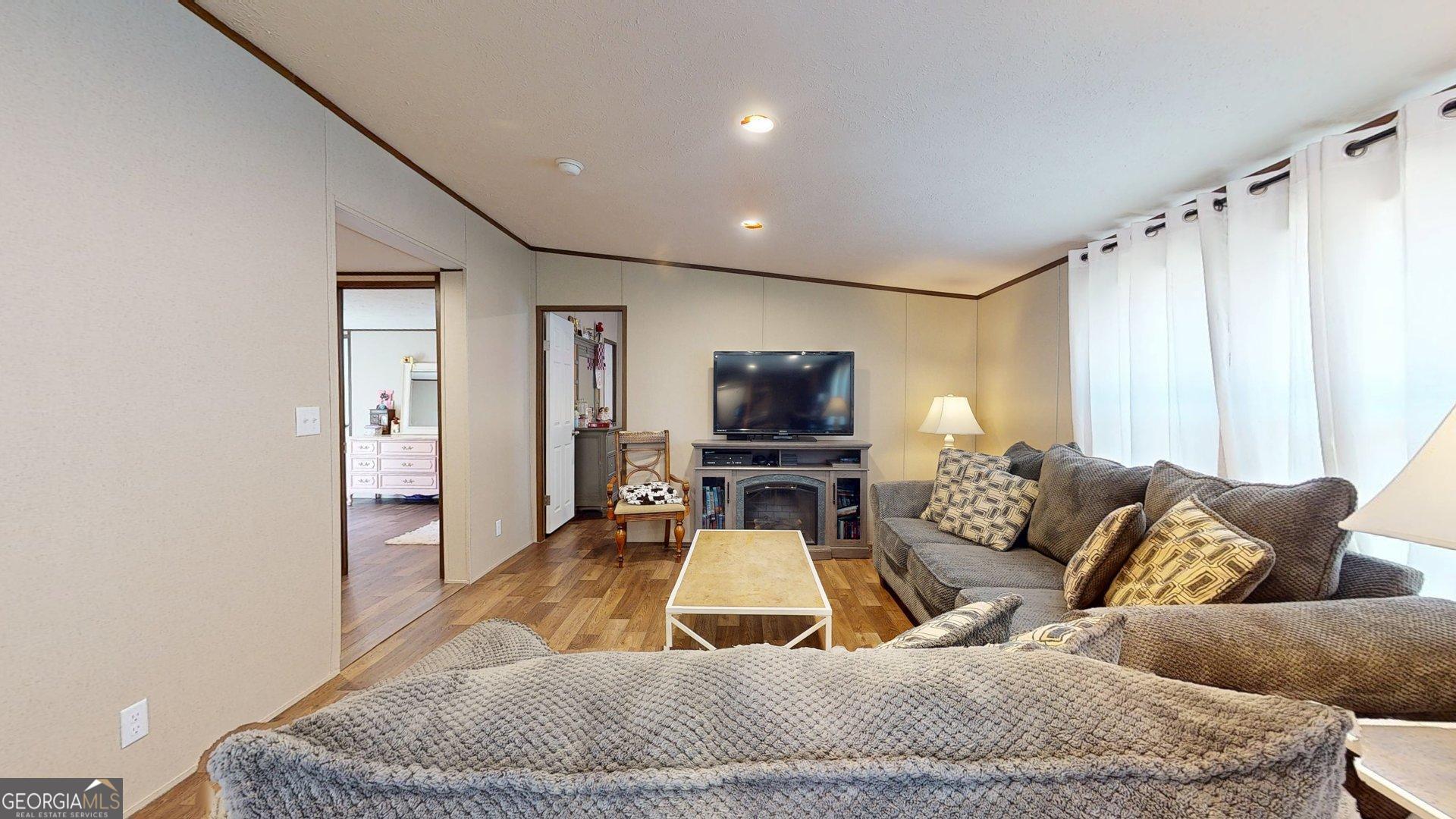 5571 Old Dixie Highway South Springfield, GA 31329 - Photo 10 of 38 a living room with furniture and a flat screen tv