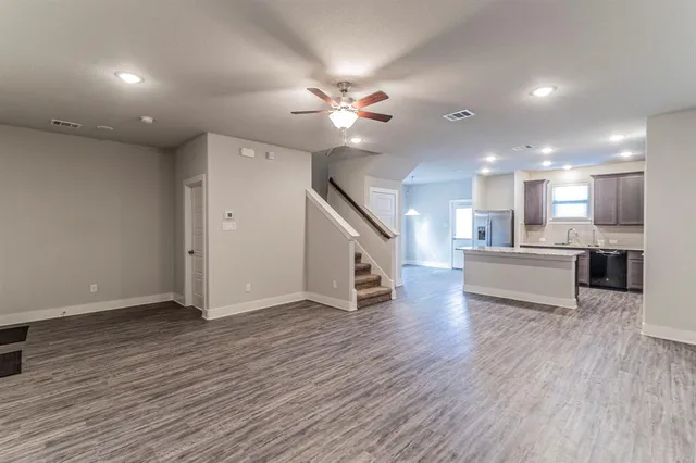 a view of a kitchen with wooden floor and a kitchen