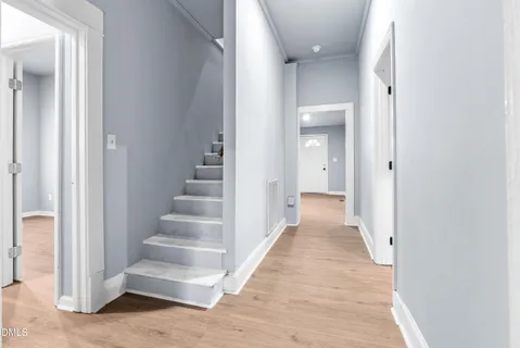 a view of an empty room with wooden floor
