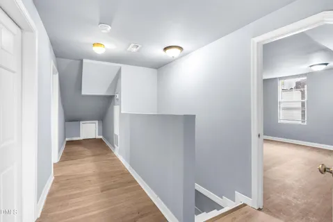 a view of staircase with white walls