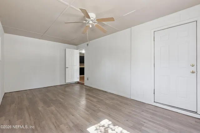 a room with a bed and a mirror