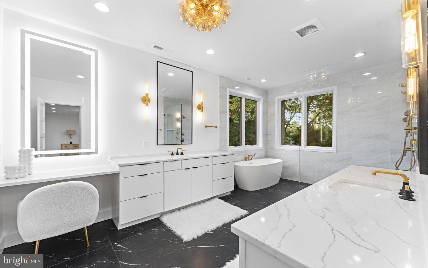 6330 Cross Street McLean, VA 22101 - Photo 16 of 19 a spacious bathroom with a double vanity sink large mirror and a bathtub