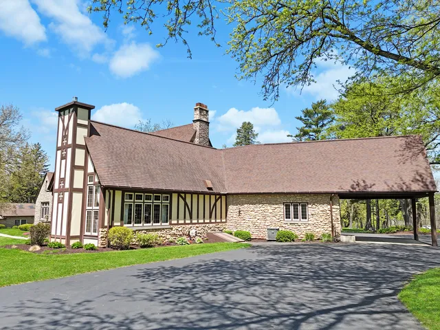 a bathroom with a granite countertop sink a mirror and a shower