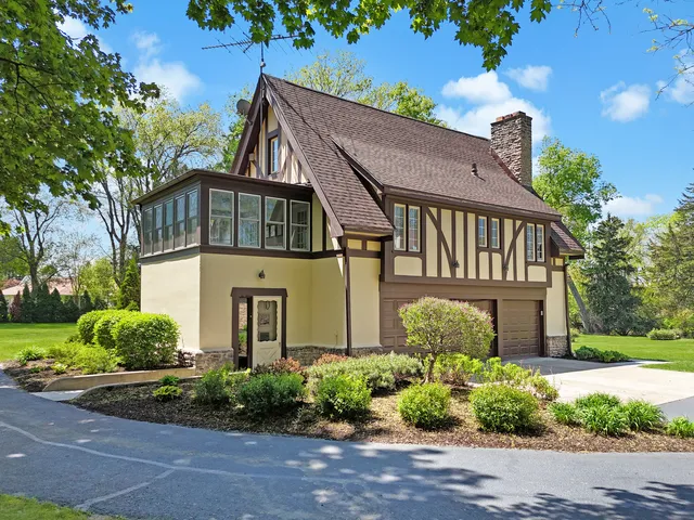 a bedroom with a large bed and a flat tv screen on dresser