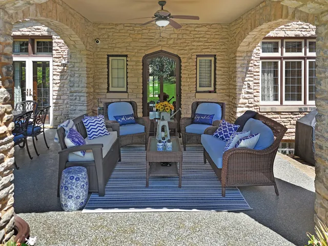 a dining room with furniture a chandelier and wooden floor