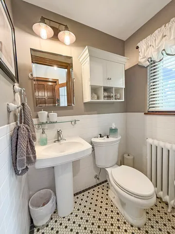 a living room with stainless steel appliances kitchen island granite countertop furniture and a wooden floors