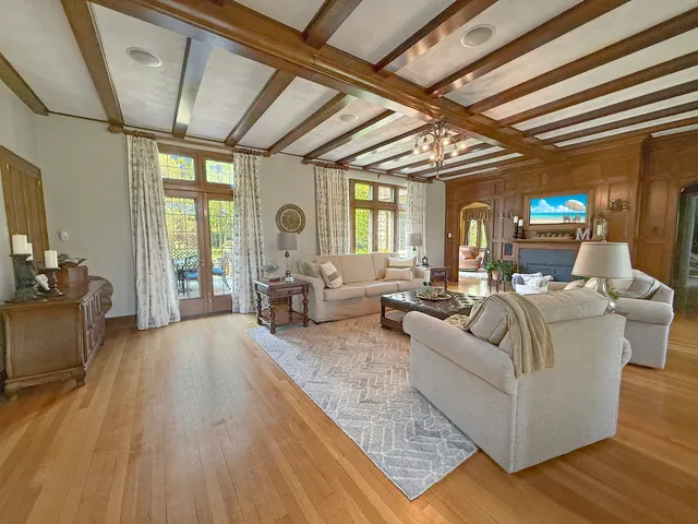 a spacious bedroom with a bed and wooden floor