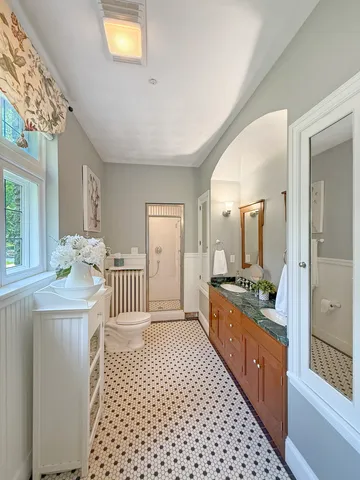 a bathroom with a sink toilet and shower