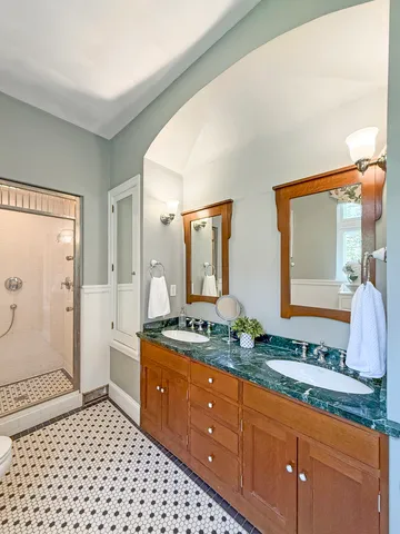 a bathroom with a sink toilet and mirror