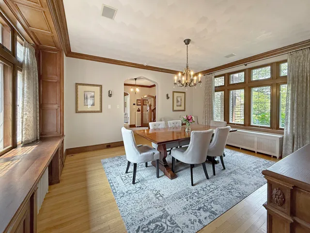 a view of a green field with trees in the background