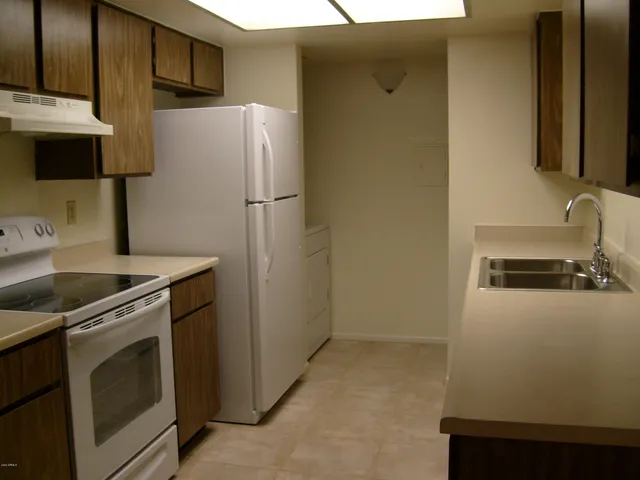 a kitchen with a refrigerator sink and stove