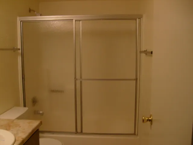 a bathroom with a glass shower door