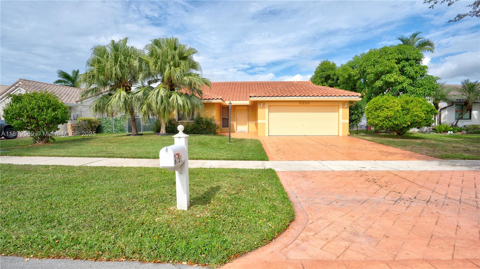 6255 Hawkes Bluff Avenue Davie, FL 33331 - Photo 11 of 51 a front view of a house with a yard and garage