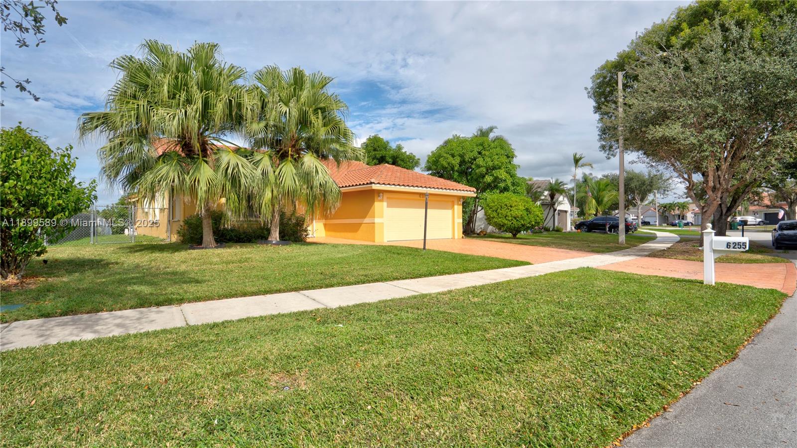 6255 Hawkes Bluff Avenue Davie, FL 33331 - Photo 12 of 51 a front view of a house with a yard