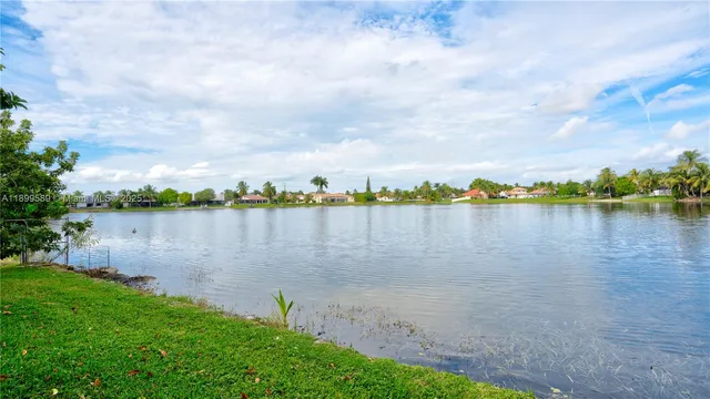 a view of a lake with houses in the back