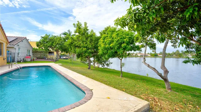 a view of a swimming pool with a yard