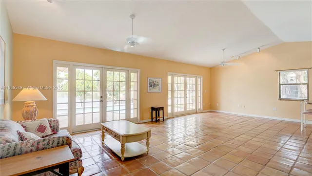 a living room with furniture and a floor to ceiling window