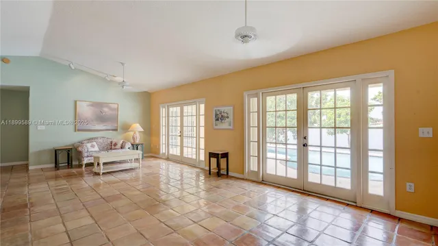 a living room with furniture and large windows