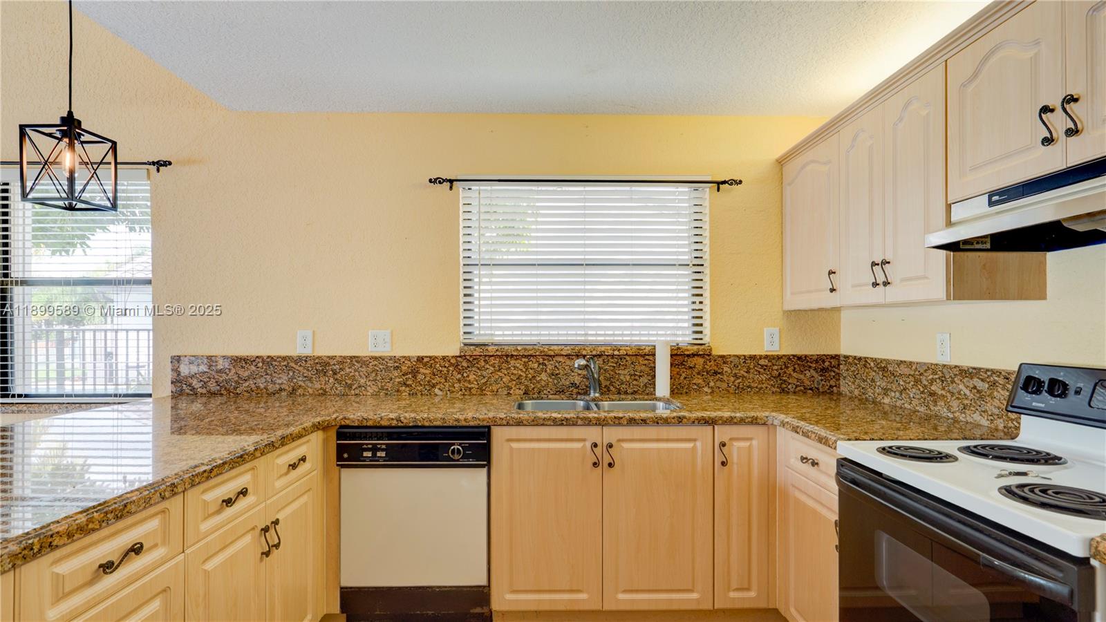 6255 Hawkes Bluff Avenue Davie, FL 33331 - Photo 26 of 51 a kitchen with granite countertop a sink stove and cabinets
