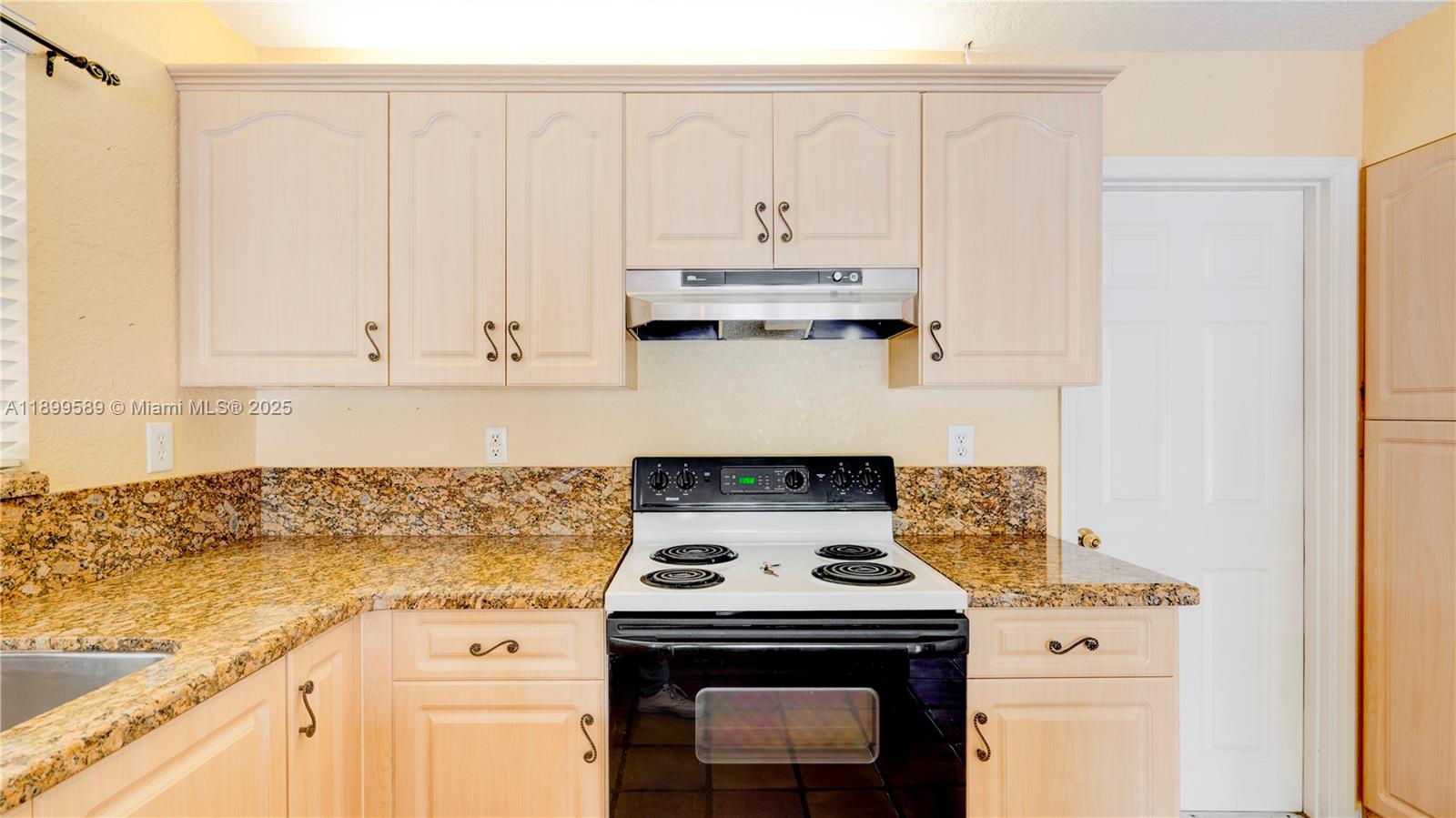 6255 Hawkes Bluff Avenue Davie, FL 33331 - Photo 27 of 51 a stove top oven sitting inside of a kitchen