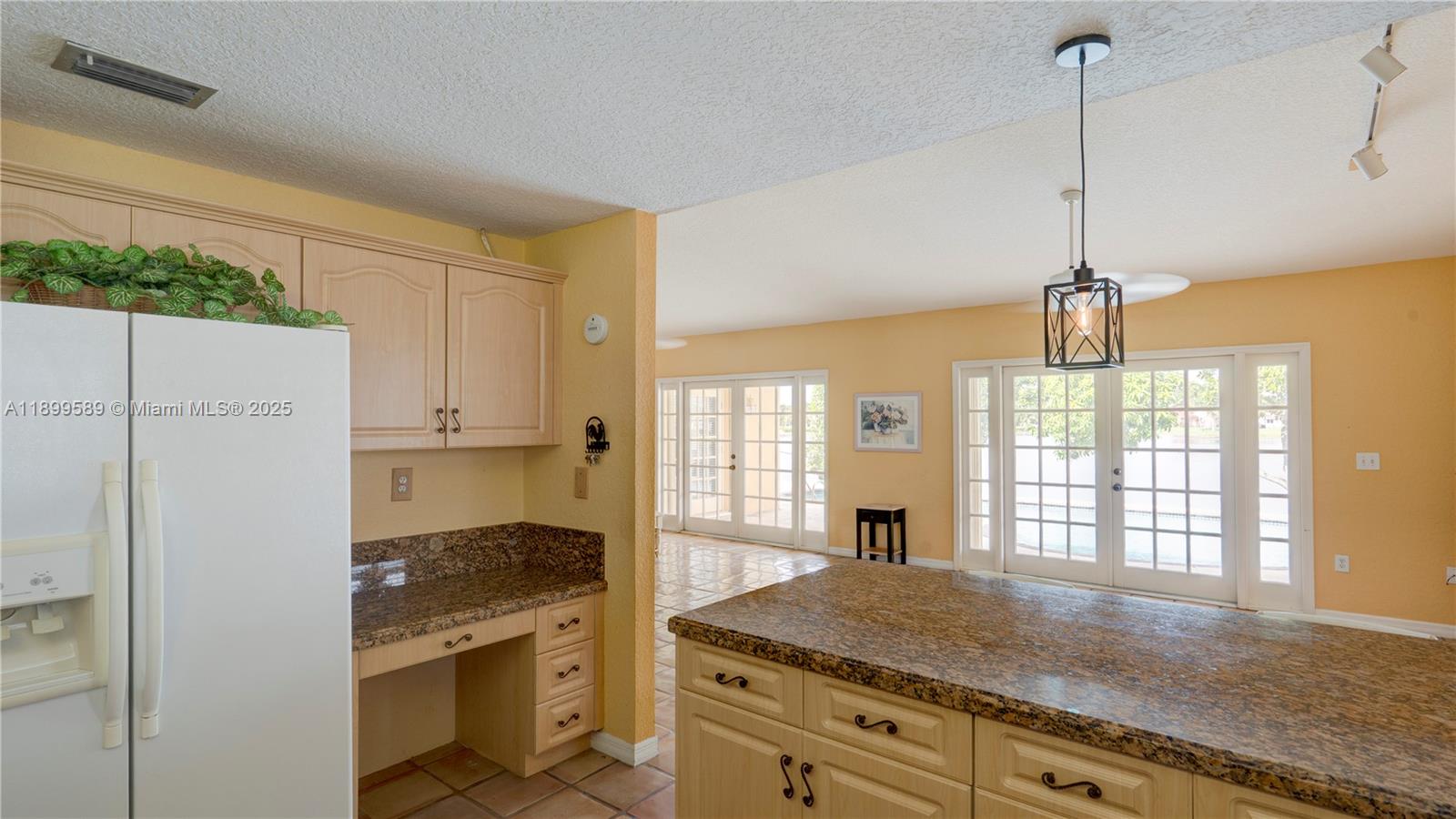 6255 Hawkes Bluff Avenue Davie, FL 33331 - Photo 29 of 51 a kitchen with stainless steel appliances granite countertop a refrigerator a sink dishwasher and white cabinets with wooden floor